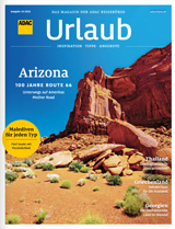 Ein Reisemagazin zeigt eindrucksvolle rote Felsenlandschaft unter blauem Himmel